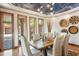 Dining room features a wooden table, upholstered chairs, modern light fixture, and hardwood floors at 11988 E Larkspur Dr, Scottsdale, AZ 85259