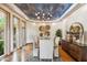 Dining room features a wooden table, upholstered chairs, an artistic ceiling, and hardwood floors at 11988 E Larkspur Dr, Scottsdale, AZ 85259