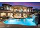 Luxury home exterior with pool, waterfall feature, and private basketball court at 11988 E Larkspur Dr, Scottsdale, AZ 85259