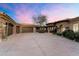 Spacious three-car garage with stone accents and a large driveway, perfect for car enthusiasts at 11988 E Larkspur Dr, Scottsdale, AZ 85259