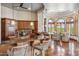 Spacious kitchen with stainless appliances, granite countertops, custom wood cabinets, and stylish bar seating at 11988 E Larkspur Dr, Scottsdale, AZ 85259