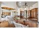 Stylish kitchen boasts wood cabinets, granite counters, island seating, and an open layout at 11988 E Larkspur Dr, Scottsdale, AZ 85259