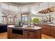 Open gourmet kitchen with granite countertops, custom cabinetry, modern lighting, and stainless appliances at 11988 E Larkspur Dr, Scottsdale, AZ 85259