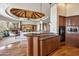 Gourmet kitchen with custom wood cabinetry, granite countertops, and open layout to living area at 11988 E Larkspur Dr, Scottsdale, AZ 85259