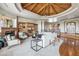 Bright and open living room features a fireplace, built-ins, stylish seating, and beamed ceiling at 11988 E Larkspur Dr, Scottsdale, AZ 85259