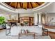 Comfortable living room featuring custom built-ins, fireplace, stylish seating and beamed ceiling at 11988 E Larkspur Dr, Scottsdale, AZ 85259