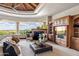 Bright living room with a fireplace, custom built-ins, comfortable seating and gorgeous mountain view at 11988 E Larkspur Dr, Scottsdale, AZ 85259