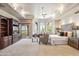 A luxurious main bedroom boasts a seating area, large windows, and a built-in entertainment center with view at 11988 E Larkspur Dr, Scottsdale, AZ 85259