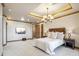 Large main bedroom with wood trim, ensuite, and a wall-mounted television at 11988 E Larkspur Dr, Scottsdale, AZ 85259