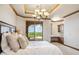 A lavish main bedroom boasts a balcony with spectacular views and an ensuite at 11988 E Larkspur Dr, Scottsdale, AZ 85259