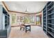 The spacious office features a desk, built-in shelving, and a sliding glass door to an outdoor balcony area at 11988 E Larkspur Dr, Scottsdale, AZ 85259