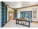 Office area with custom built-in shelving and sleek desk at 11988 E Larkspur Dr, Scottsdale, AZ 85259