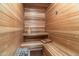 Luxurious sauna featuring wooden benches, paneling, and traditional sauna equipment at 11988 E Larkspur Dr, Scottsdale, AZ 85259