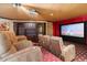 Comfortable home theater with a large screen, projector and custom cabinetry for an immersive viewing experience at 11988 E Larkspur Dr, Scottsdale, AZ 85259