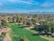 Wide aerial captures a vibrant golf course, homes, and distant mountain views at 12034 N 61St St, Scottsdale, AZ 85254