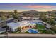 An aerial view shows the inviting backyard, pool, and outdoor dining area of this home at 12034 N 61St St, Scottsdale, AZ 85254