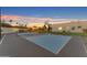 Backyard basketball court offers recreation and fitness, set against a colorful evening sky at 12034 N 61St St, Scottsdale, AZ 85254