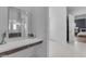 Bathroom vanity area, blending functionality and design with a minimalist mirror and a view of the bedroom at 12034 N 61St St, Scottsdale, AZ 85254