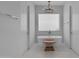Bright bathroom with a freestanding tub, chandelier, and stool creating a serene spa-like retreat at 12034 N 61St St, Scottsdale, AZ 85254