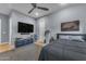 This contemporary bedroom includes a large TV, ceiling fan, and ample storage, offering both comfort and functionality at 12034 N 61St St, Scottsdale, AZ 85254