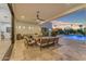 Covered patio featuring comfortable seating and seamless access to the pool and backyard at 12034 N 61St St, Scottsdale, AZ 85254