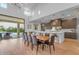 Elegant dining area featuring a long wooden table, modern chairs, and an open view of the kitchen at 12034 N 61St St, Scottsdale, AZ 85254