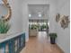 Bright foyer featuring light wood floors, stylish decor, and an open view to the living area at 12034 N 61St St, Scottsdale, AZ 85254