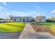 Inviting front yard with lush green grass and stone pathway leading to the modern home at 12034 N 61St St, Scottsdale, AZ 85254