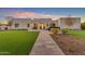 Modern home featuring sleek architectural lines, lush landscaping, and a grand entrance at 12034 N 61St St, Scottsdale, AZ 85254