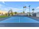 Well-maintained outdoor sport court with basketball hoop and tennis net at 12034 N 61St St, Scottsdale, AZ 85254