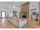 Spacious living room boasting high ceilings, modern chandelier, and a cozy fireplace with TV at 12034 N 61St St, Scottsdale, AZ 85254