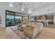 Bright living area with sliding glass doors opening to a patio and connecting to the modern kitchen at 12034 N 61St St, Scottsdale, AZ 85254
