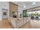 Modern living room with fireplace, high ceilings, and access to covered patio and pool at 12034 N 61St St, Scottsdale, AZ 85254
