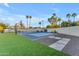 Backyard sport court with basketball hoop and tennis net on artificial turf at 12034 N 61St St, Scottsdale, AZ 85254