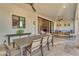 Charming covered patio with dining and lounge areas, connecting indoor and outdoor living spaces seamlessly at 12034 N 61St St, Scottsdale, AZ 85254