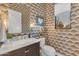 Chic powder room with patterned wallpaper, stylish mirror, and a window, offering a unique aesthetic at 12034 N 61St St, Scottsdale, AZ 85254