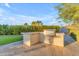 Modern outdoor kitchen with built-in grill, bar and ample counter space at 12034 N 61St St, Scottsdale, AZ 85254
