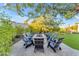 Outdoor firepit surrounded by comfortable seating and green lawn at 12034 N 61St St, Scottsdale, AZ 85254