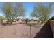 Expansive backyard with desert landscaping featuring mature trees and views of the home's back facade at 14507 W Christy Dr, Surprise, AZ 85379