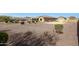 Spacious backyard featuring desert landscaping, patio, swimming pool, an outdoor kitchen, and plenty of room at 14507 W Christy Dr, Surprise, AZ 85379
