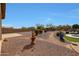 A sprawling backyard featuring a rock landscape, beautiful plants, and a tranquil fountain at 14507 W Christy Dr, Surprise, AZ 85379
