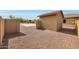 Backyard featuring a storage shed, desert landscaping, and block wall fencing at 14507 W Christy Dr, Surprise, AZ 85379