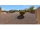 Expansive backyard with rock landscaping and a gazebo in the distance, offering a serene outdoor retreat at 14507 W Christy Dr, Surprise, AZ 85379