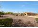 Vast backyard showing desert landscaping, a swimming pool, an outdoor kitchen, and generous patio space at 14507 W Christy Dr, Surprise, AZ 85379