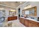 A spacious bathroom featuring a soaking tub, glass shower, and dual sink vanity at 14507 W Christy Dr, Surprise, AZ 85379