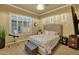 Bedroom with large window, gray and white bedding, and a dark wood floor at 14507 W Christy Dr, Surprise, AZ 85379