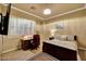 A bedroom with a desk and bed near a large window at 14507 W Christy Dr, Surprise, AZ 85379