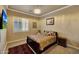 A well-lit bedroom featuring neutral walls, carpet, and a paisley bedding at 14507 W Christy Dr, Surprise, AZ 85379