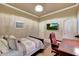 A bedroom with a TV, desk, and neutral-colored walls at 14507 W Christy Dr, Surprise, AZ 85379