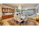 Elegant dining area features a marble table, upholstered chairs, chandelier, and built-in bar for entertaining at 14507 W Christy Dr, Surprise, AZ 85379